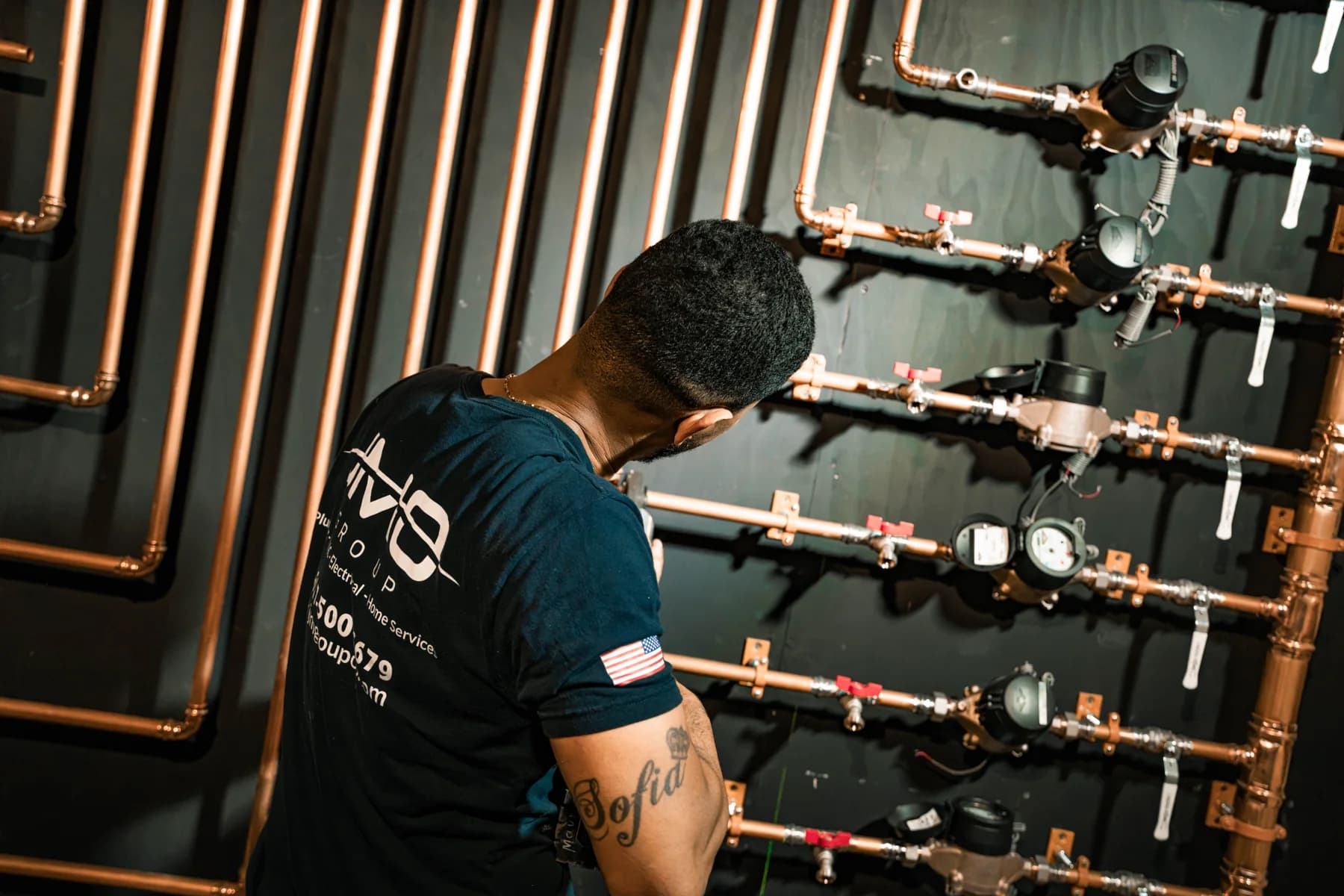 JMO technician working on a copper plumbing manifold