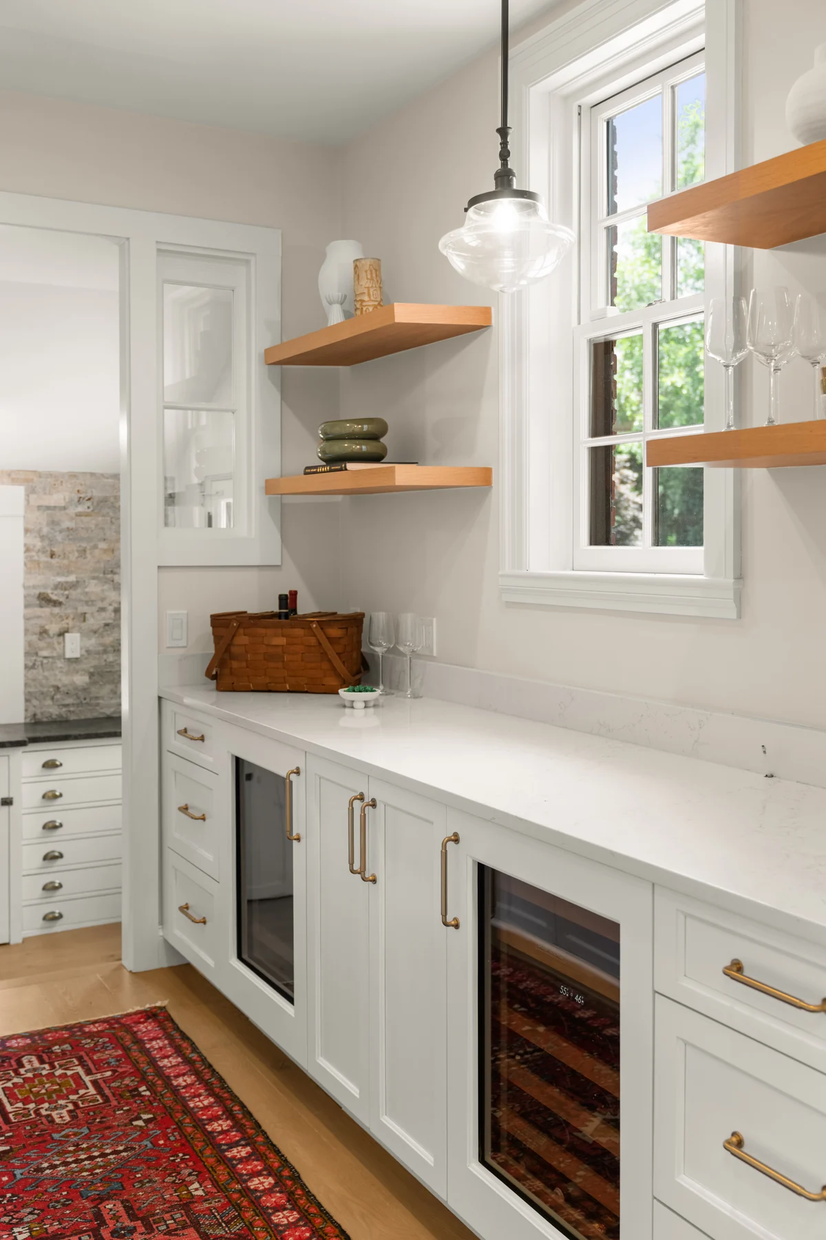 White pantry cabinetry with brass hardware and open shelving at 372 Warren Street