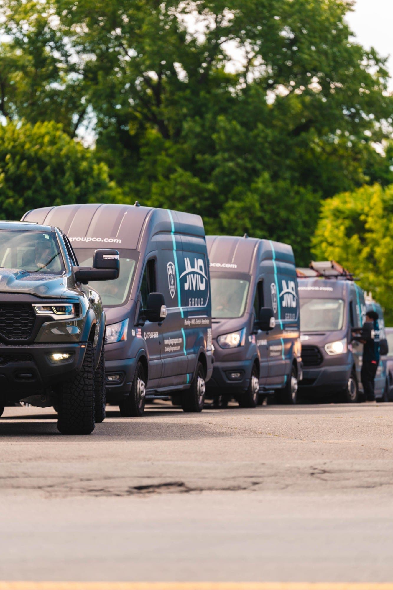JMO Group service vans and truck on the road