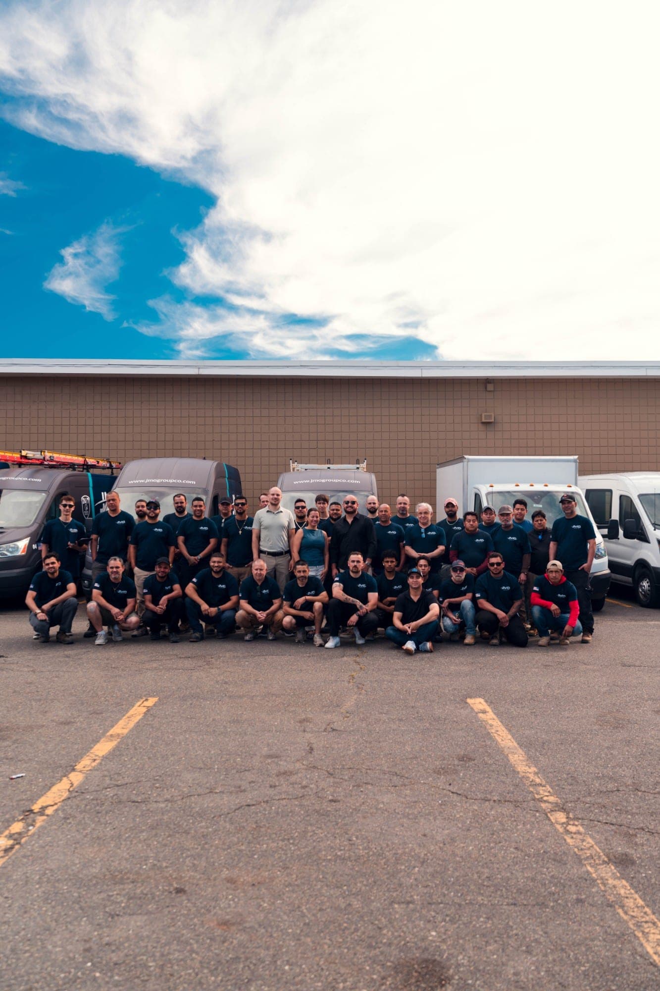 The JMO Group team in front of the company fleet