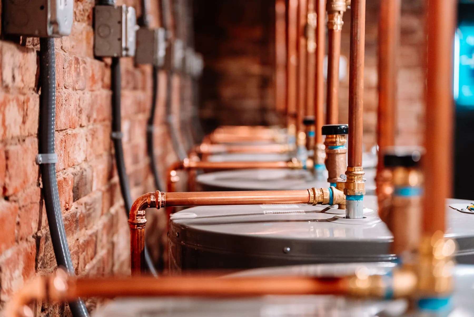 Copper pipework and water-heating equipment in a mechanical room