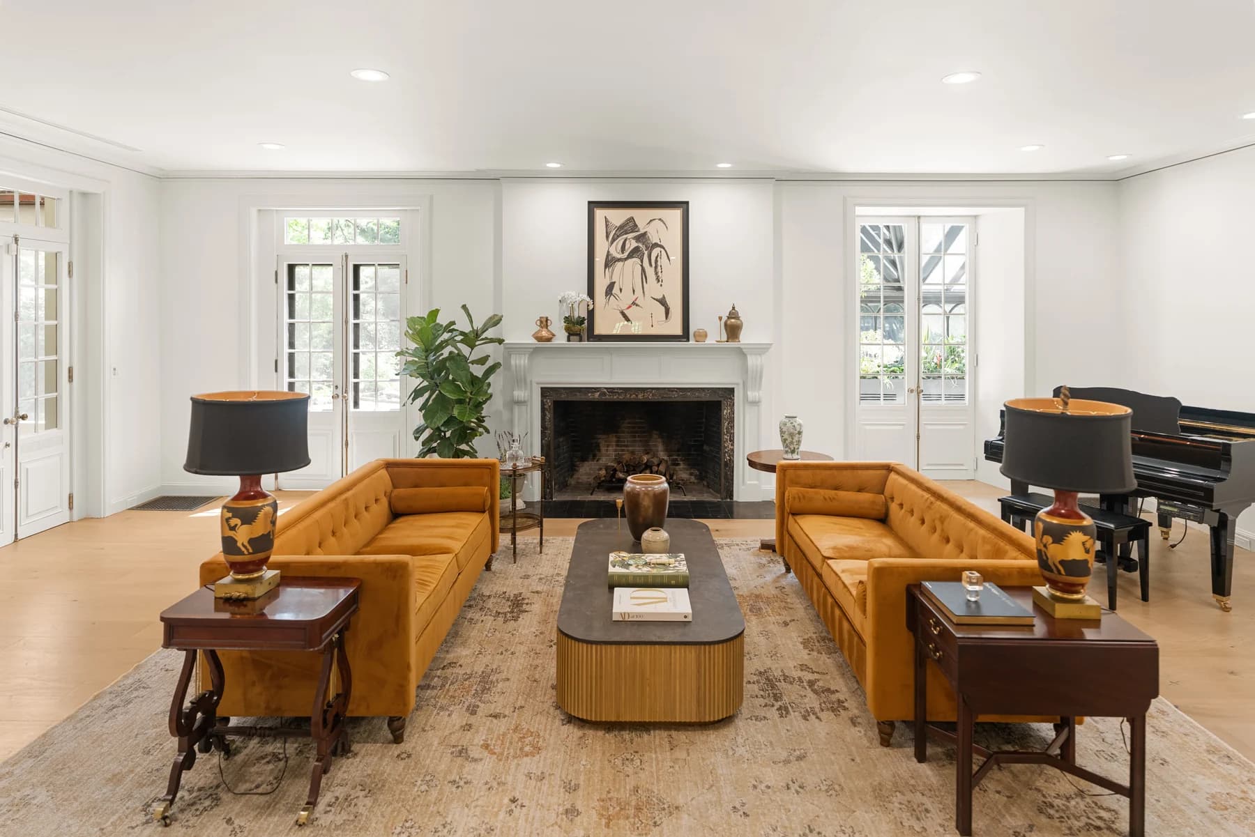 Finished living room with a fireplace, detailed white trim, and wood flooring at 372 Warren Street